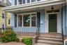 Doorway to residence with a porch