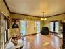 Sitting room with baseboard heating, ornamental molding, a notable chandelier, and wood-type flooring