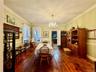 Dining space with crown molding, a notable chandelier, and dark hardwood / wood-style flooring