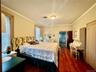 Bedroom with ornamental molding and dark hardwood / wood-style flooring