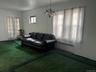 Living area featuring radiator heating unit, dark colored carpet, a chandelier, and french doors