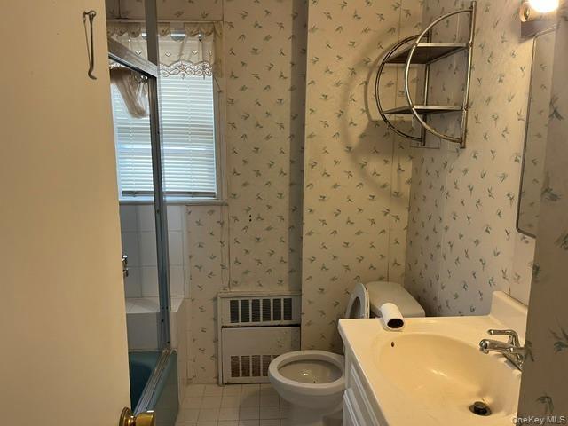Full bath featuring wallpapered walls, vanity, light tile patterned flooring, and shower / washtub combination