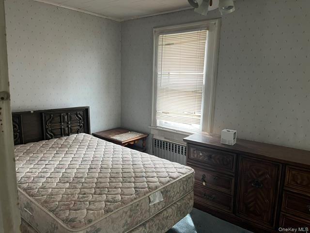 Bedroom with radiator heating unit