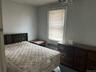 Bedroom with radiator heating unit