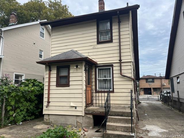 Back of house with a chimney