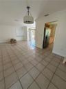 Ceramic tile flooring throughout the area, drum-style pendant lighting, and crown molding