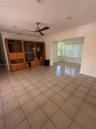 Ceramic tile flooring, recessed lighting, crown molding, and a ceiling fan
