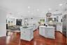 An impressive open concept chef’s kitchen, both expensive countertops, a generous, entertaining bar and a Spacious Center, Island perfectly designed f
