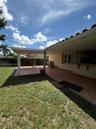 Covered patio featuring tiled flooring, built-in outdoor counter, and tile roof