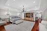 Another perspective of this extraordinary primary suite reveals its remarkable scale and versatility with room for a king size bed, a substantial sitt