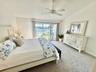 Primary Suite on the Upper Level With Waterview from Private Deck.