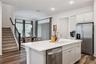 Kitchen Overlooks Living and Dining Rooms