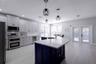 Newly renovated kitchen and large quartz island with stainless steel farmhouse sink