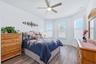 Second Bedroom with newer LPV flooring, ceiling fan and plantation shutters