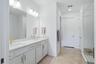 Primary Bath with double sinks, separate room for commode, walk in closet and linen closet.
