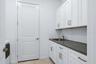 Huge laundry room with lots of workspace and custom cabinetry & countertop