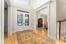 Foyer with formal dining room on right and formal living room on left