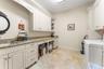 Laundry room with sink and shelving