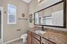 Appointed with rich granite counter surfaces, this third bath features a full tub and shower combination for modern convenience.