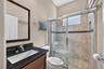 Appointed with rich granite countertops and a glass-enclosed walk-in shower, this second bath combines style and convenience.