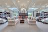 The community library offers a quiet, sunlit retreat complete with cozy seating and a rich collection of books for resident enjoyment.