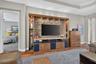 Positioned off the great room for optimal privacy, the main-level primary suite enjoys direct access to the lanai and pool.