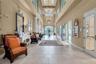 The clubhouse grand hallway features soaring ceilings and elegant architectural details, welcoming residents to the heart of the community.