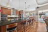 Durable granite countertops and rich wooden cabinetry elevate the kitchen, while a generous peninsula offers both extra storage and a welcoming spot f