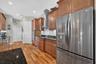 Warm wood floors, sleek stainless steel appliances, and built-in convection microwave and oven units make this kitchen a chef's dream for culinary cre