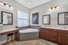 The spa-inspired en-suite bath features an oversized garden tub, offering a tranquil retreat for evening relaxation.