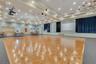 The community center features a built-in stage and spacious dance floor, ideal for hosting social events, performances, and neighborhood celebrations.