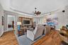 Stunning Brazilian Teak engineered hardwood flooring adds incredible depth and elegance to the spacious great room.