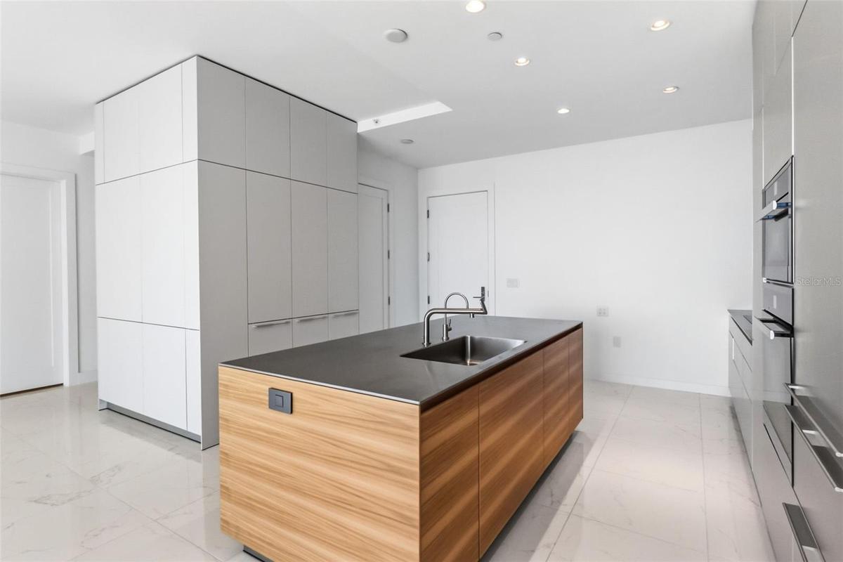 Island with Bulthaup faucet and stainless steel counters