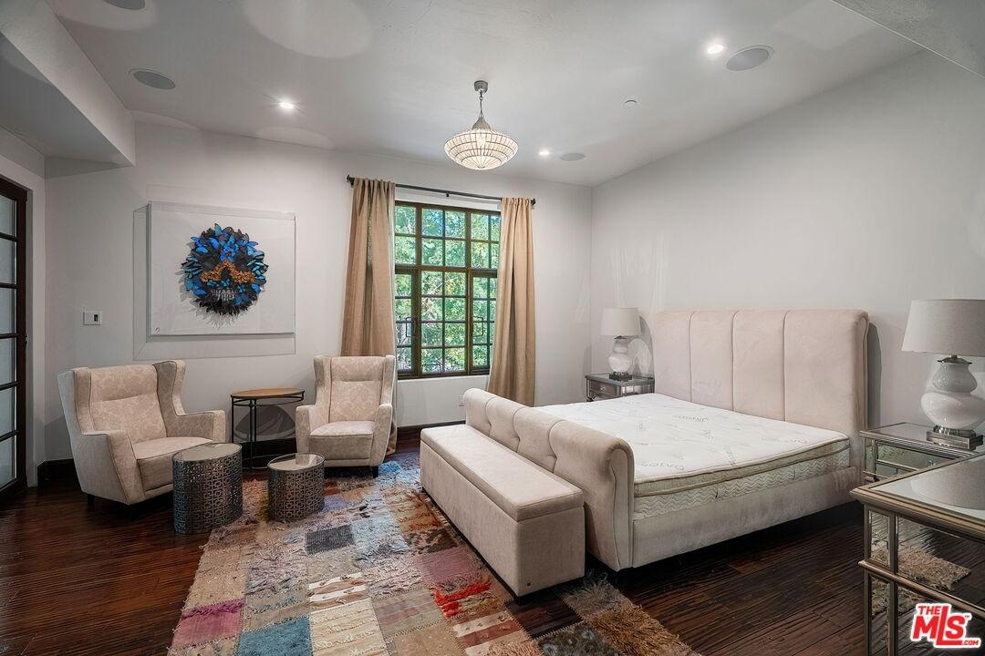 Spacious bedroom with dark woo
