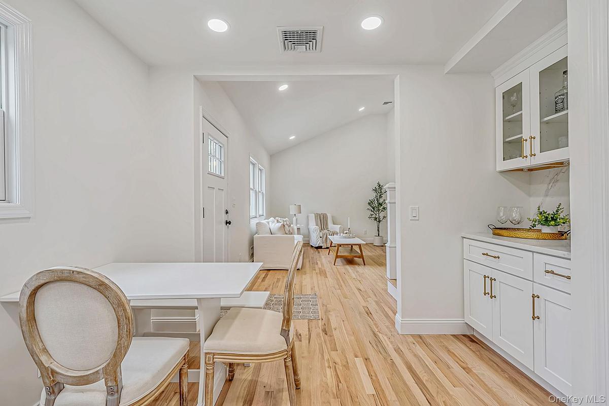 Breakfast nook in kitchen featuring perfectly designed cabinets with quarts counters
