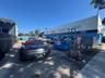 Commercial structure with concrete masonry unit construction, fenced exterior lot, and paved surfacing