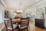 Dining space continues with wood-finish tile flooring, crown molding, and recessed lighting.
