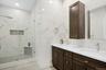 Hall spa-inspired bathroom with double sinks.