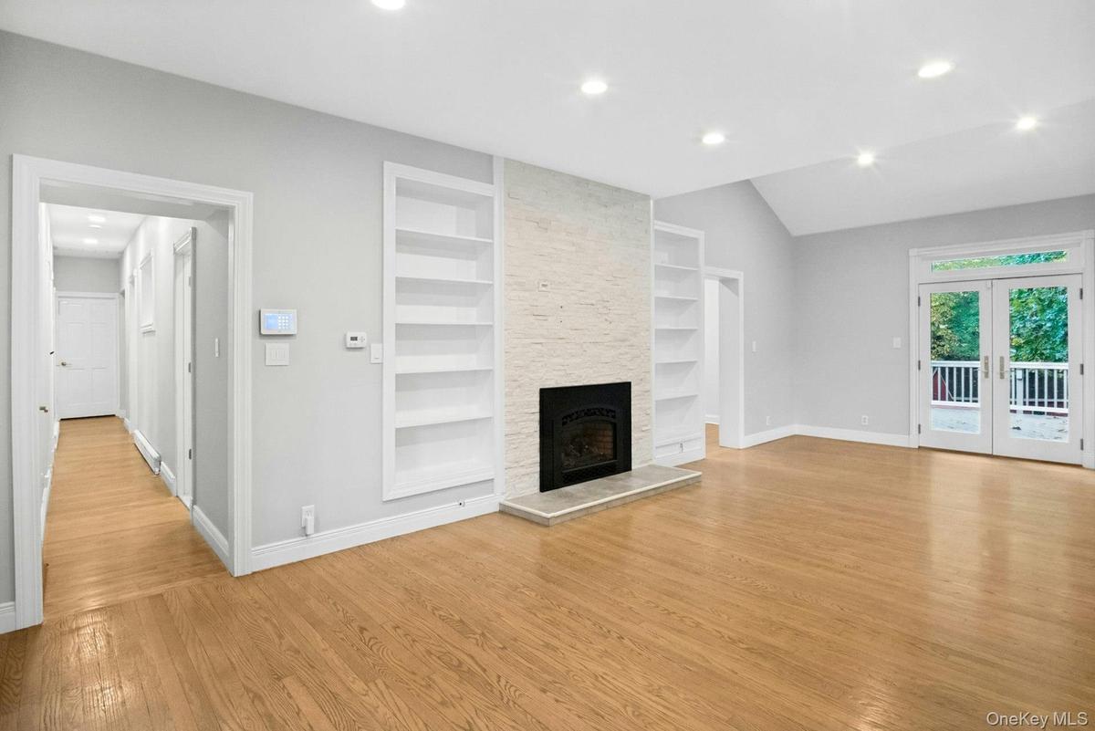 Ceiling to floor stone gas fireplace.