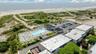 Birds eye view of property featuring a water view and a view of the beach