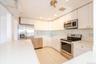 Kitchen featuring a sink, visible vents, white cabinets, and stainless steel appliances