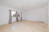Spare room featuring a ceiling fan, baseboards, light wood-type flooring, and baseboard heating