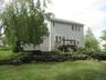 Rear exterior, deck and stone wall