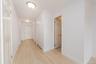 Hallway featuring light wood-style flooring and baseboards