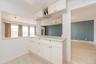 Kitchen featuring baseboard heating, white cabinetry, baseboards, and light countertops