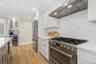 Kitchen custom fitted for the discerning chef, from the six burner gas stove, large center island, and butler's area with wine fridge and glass cabine