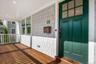 Welcoming mahogany front porch w/ copper flashing perfect for watching life pass you by.