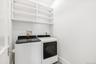 Large second floor laundry room offering excellent work space, additional storage.