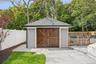 A detached garage with carriage-style door - could store kayaks, bikes and beach chairs, be used as a traditional garage or a pool house!  Blue Point 
