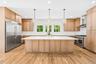The chef's kitchen: an oversized island, custom wood cabinetry and wide-plank floors. Stock it after lunch at Flo's Luncheonette, a Blue Point icon si